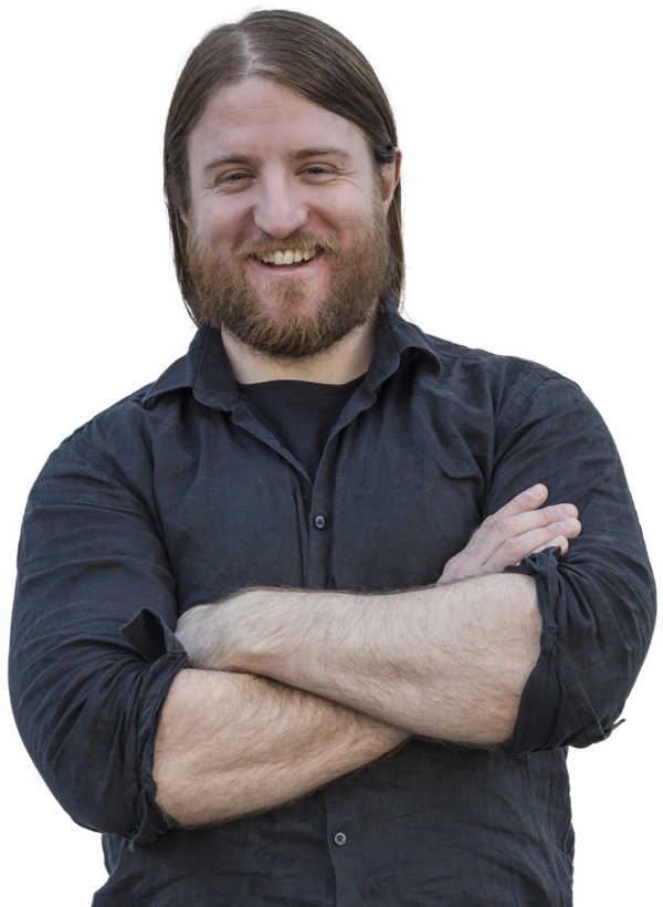 Male expat tax services specialist with friendly smile and brown hair and beard.